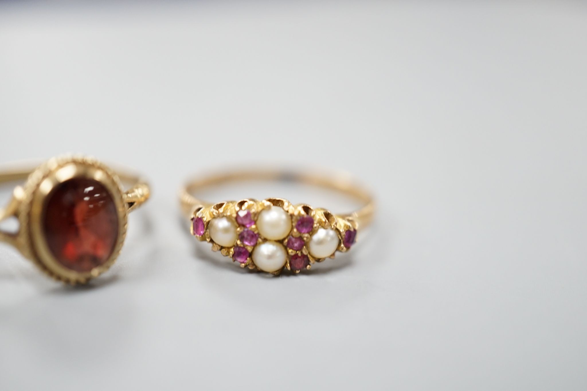 A late Victorian 15ct gold, seed pearl and amethyst cluster set ring, size L, gross 2.1 grams and two later 9ct gold rings including cameo shell, gross 3.2 grams.